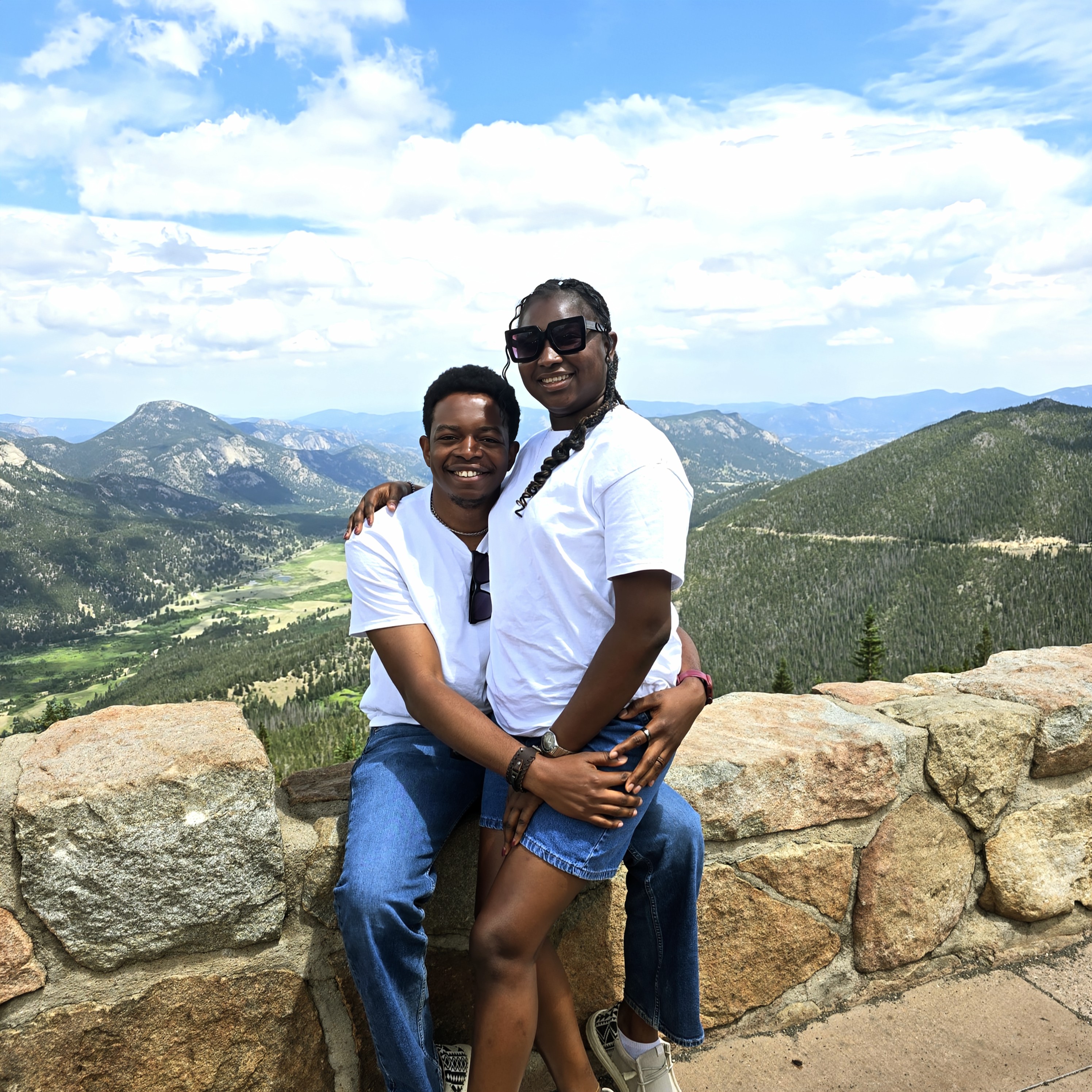 Paschal and Maryanne embracing at a mountain overlook