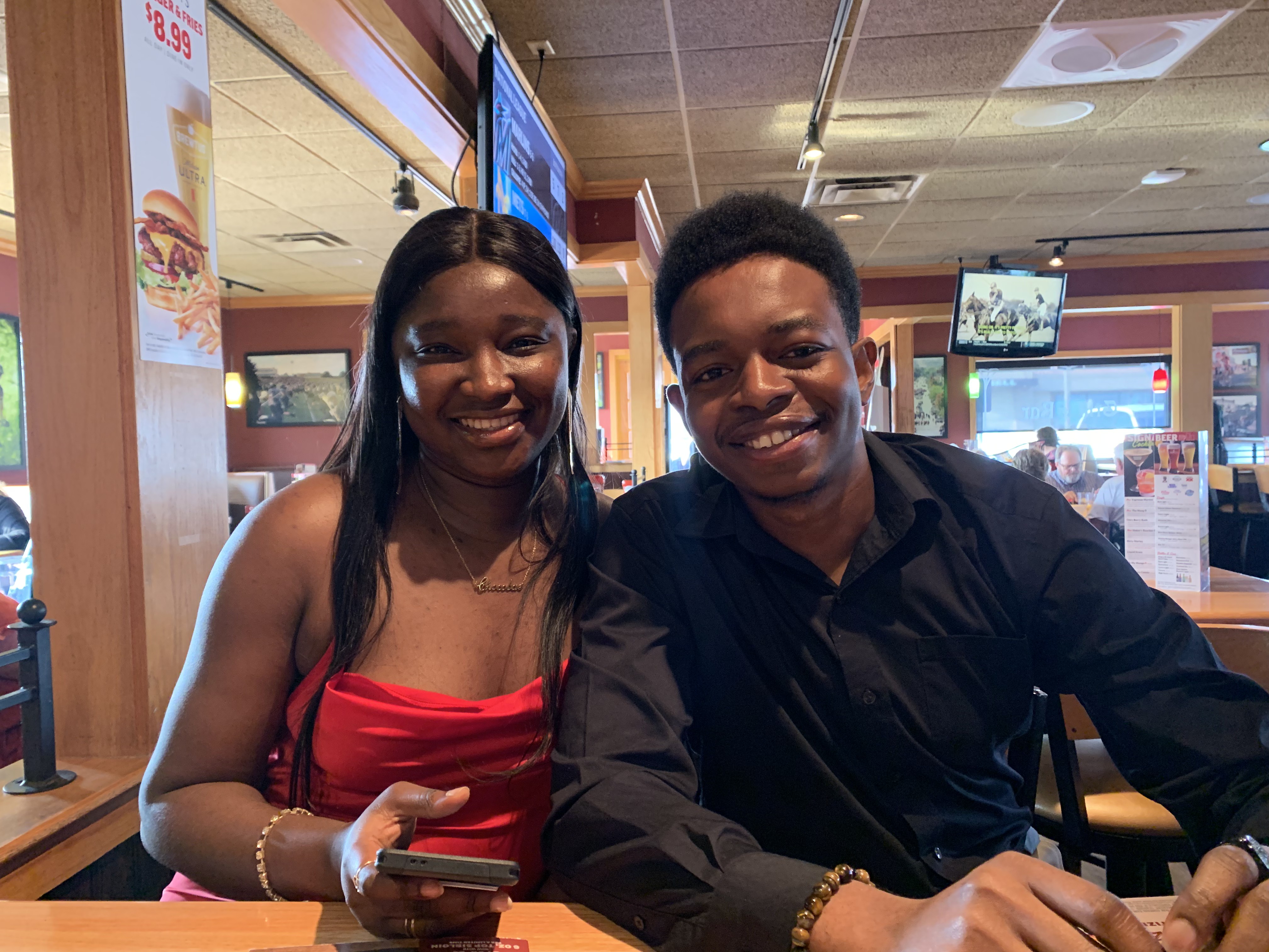 Paschal and Maryanne smiling together at a restaurant
