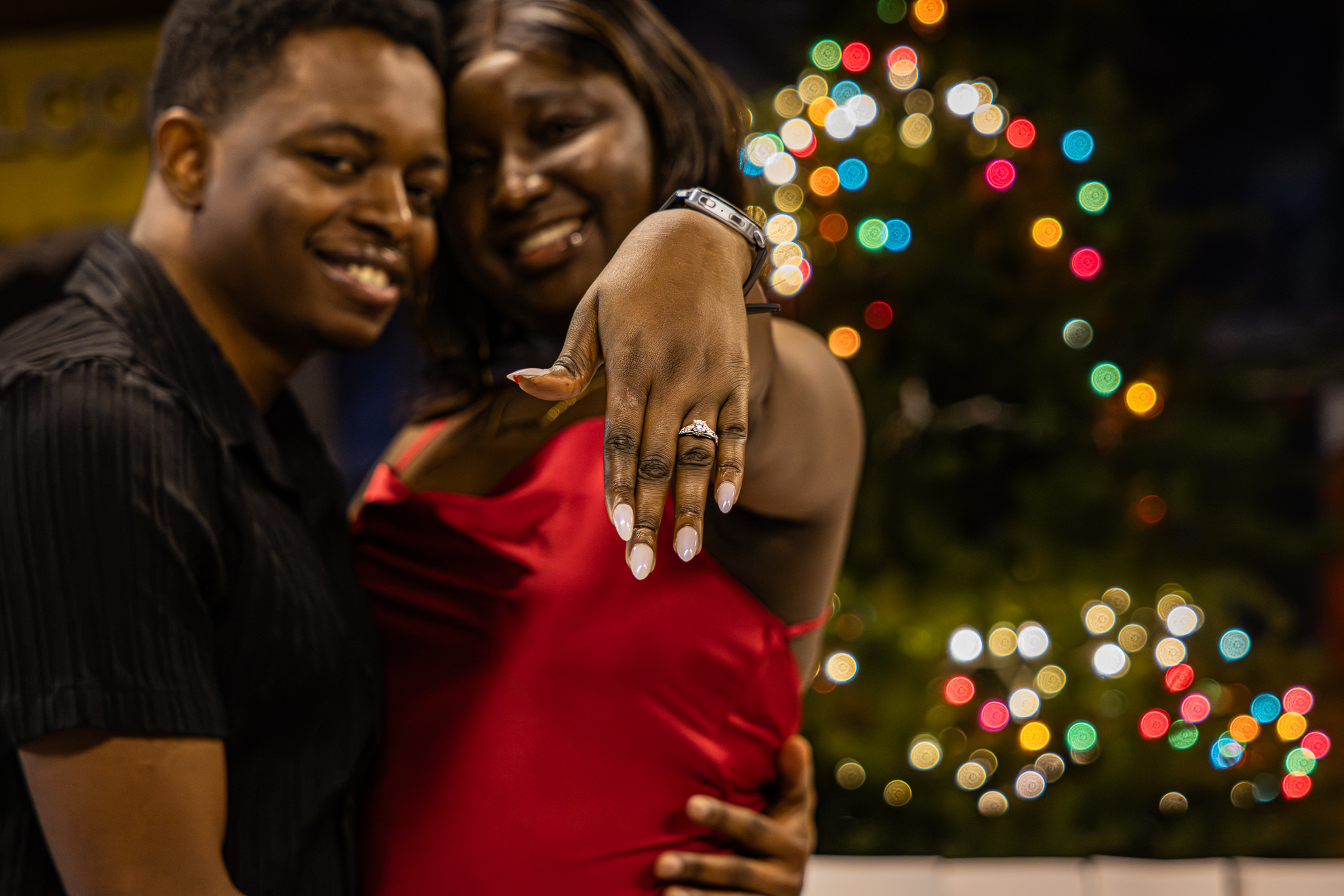 Paschal and Maryanne celebrating their engagement as Maryanne shows her ring